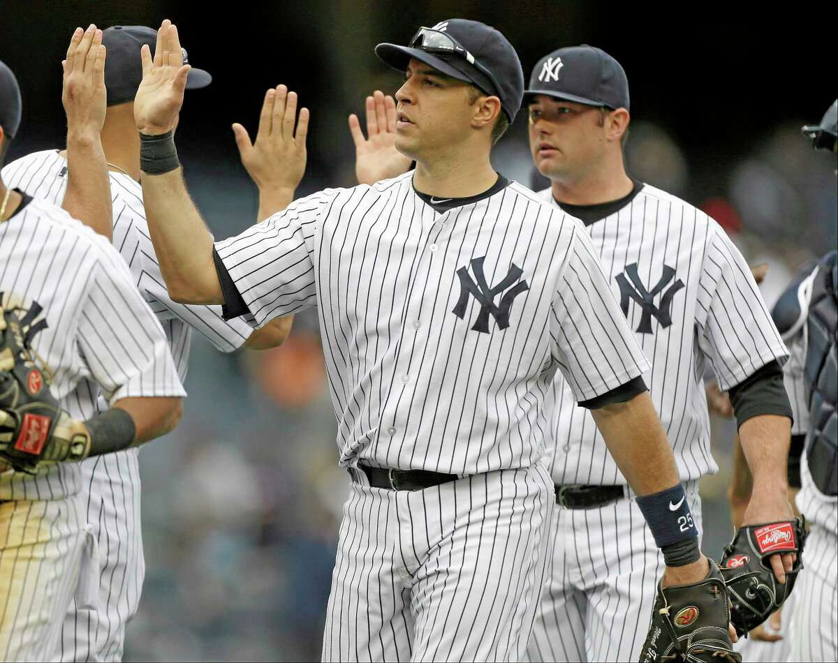 Mark Teixeira celebrates with his Yankee teammates after a 9-3 win over the Tampa Bay Rays on Saturday in New York.
