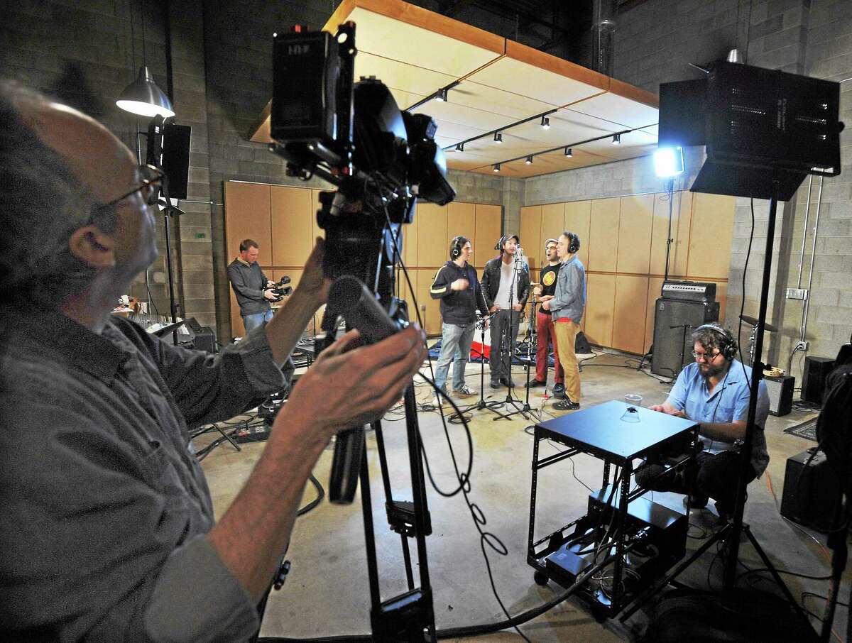 (Mara Lavitt ó New Haven Register) Four actors from the Yale Repertory Theater's production of "These Paper Bullets," from left: Lucas Papaelias, Bryan Fenkart, James Barry and David Wilson Barnes, rehearse a song for recording and use in the production. Cinematographer Mills Clark of New York City, left, and videographer David Kane of Westport captures the rehearsal while recording engineer Eric Dawson Tate makes adjustments, right.