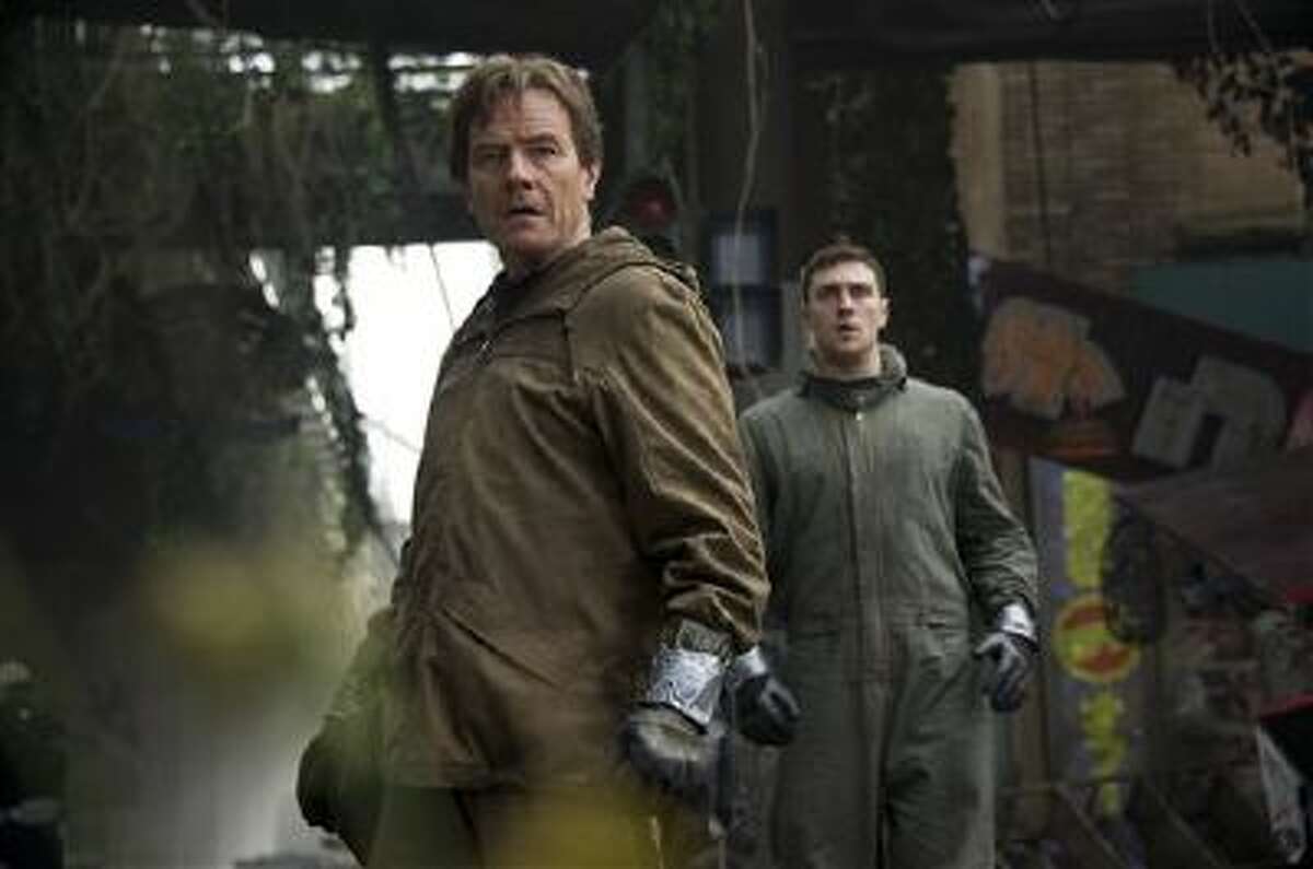 This image released by Warner Bros. Pictures shows Bryan Cranston, left, and Aaron Taylor-Johnson in a scene from "Godzilla."