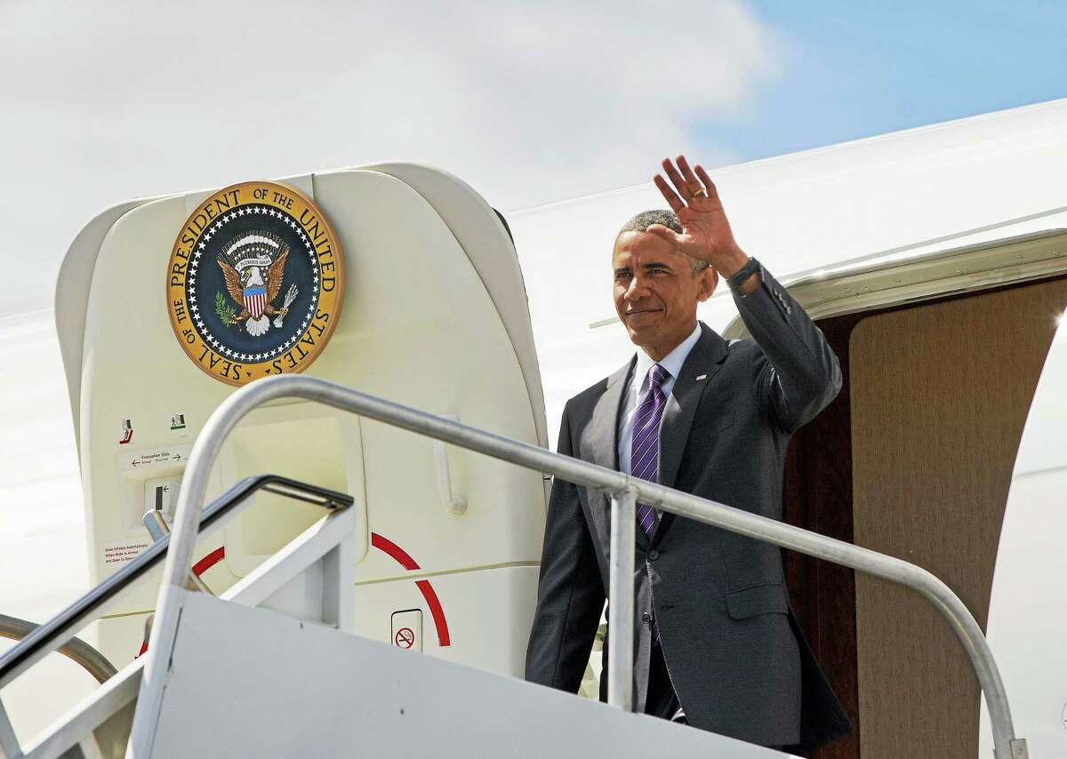 President Barack Obama waves upon his arrival at Westchester County Airport in White Plains, N.Y., Friday, Aug. 29, 2014.