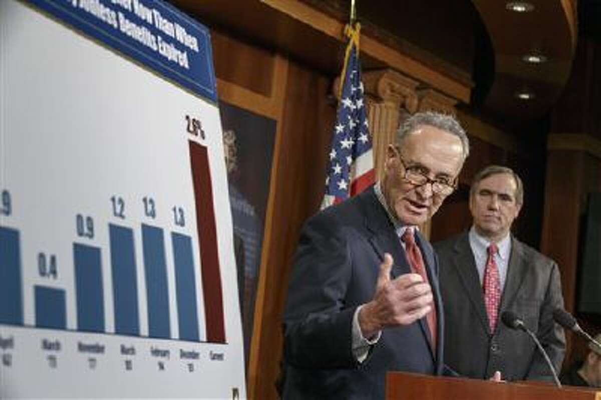 Sen. Charles Schumer, D-N.Y., joined at right by Sen. Jeff Merkley, D-Ore., meets with reporters after legislation to renew jobless benefits for the long-term unemployed unexpectedly cleared an initial Senate hurdle on Tuesday.