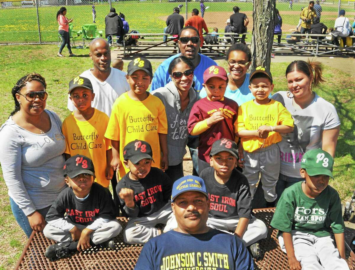Walter Pop Smith League President, Lynair Walkwe, front, with some of the children ( and their parents) who will be participating in the Freddie Fixer Parade Sunday.