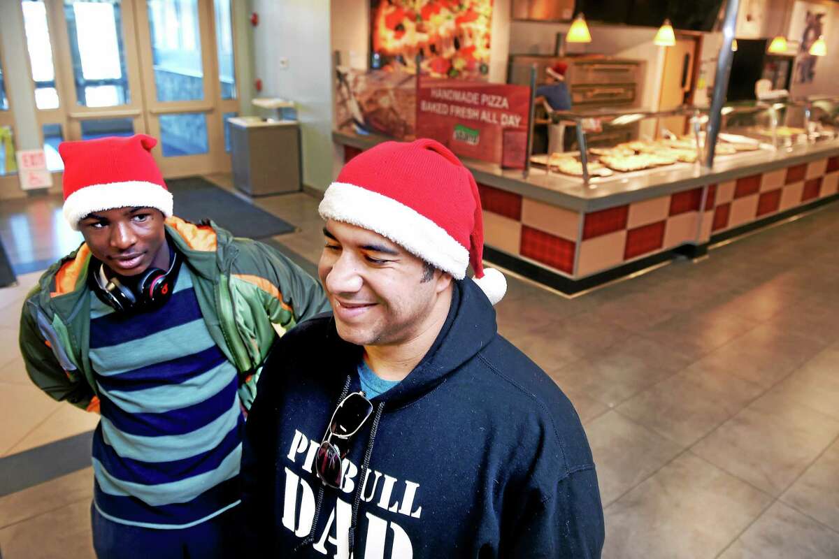 Dyoe Hostin (left) and his uncle, Carlos, of New York stop at the Connecticut Service Plaza on I-95 northbound in Milford on their way to a skiing trip near the Canadian border with others on Christmas morning December 25, 2014.