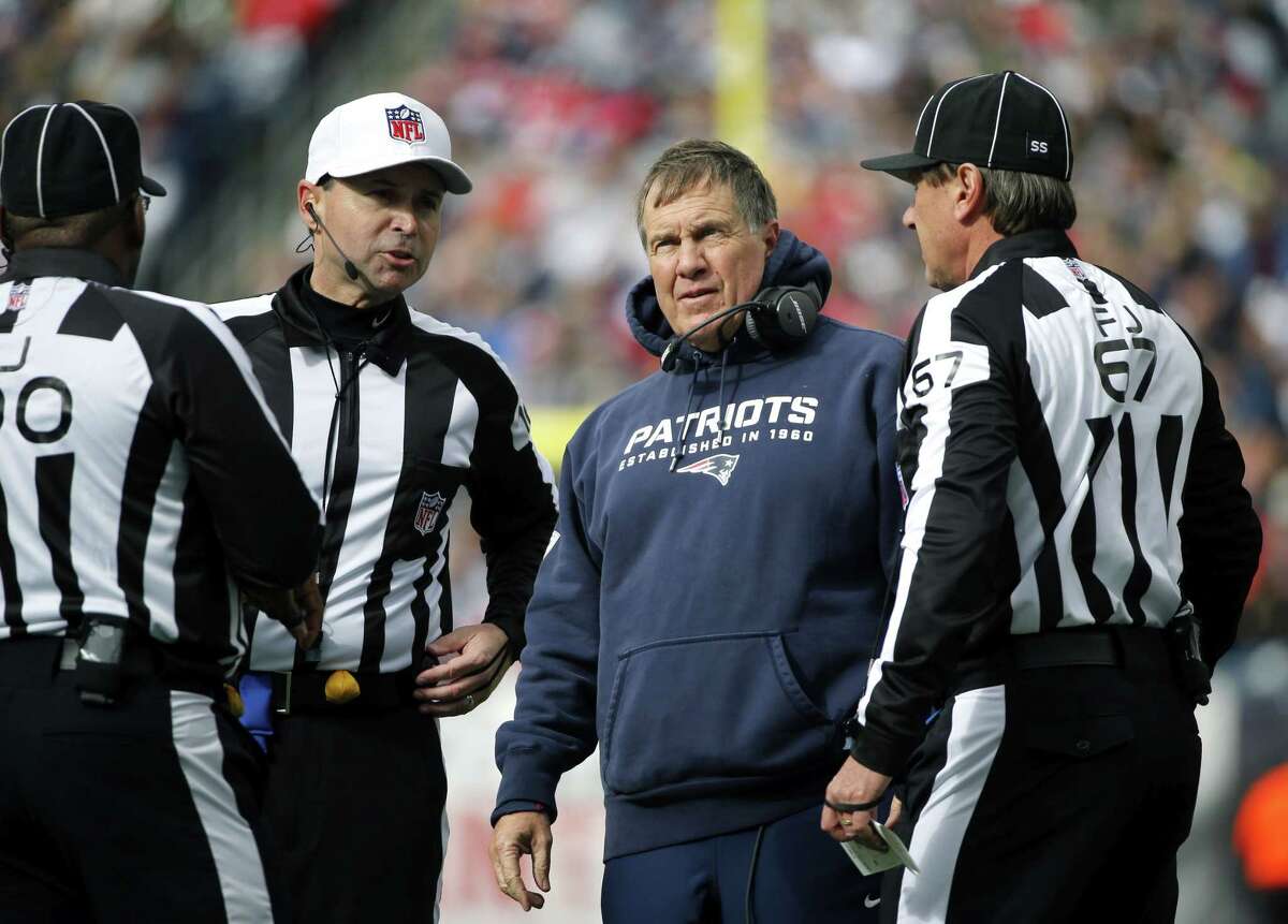 Elise Amendola — The Associated Press New England Patriots head coach Bill Belichick talks to game officials during Sunday’s game against the Bears.
