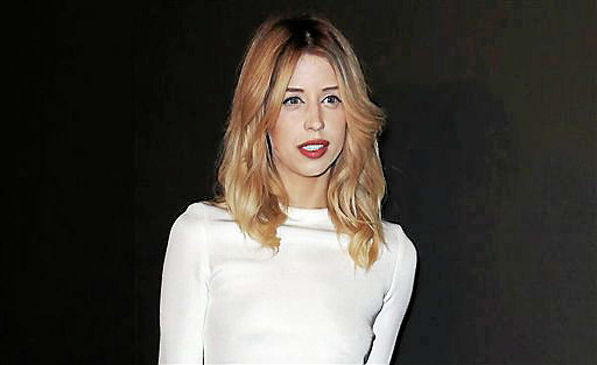 FILE - In this Tuesday, Feb. 25, 2014 file photo, Peaches Geldof arrives to attend the ETAM's ready to wear fall/winter 2014-2015 fashion collection presented in Paris. Heroin is like to have played a role in the death of 25-year-old model and television personality Peaches Geldof, authorities said Thursday. Detective Chief Inspector Paul Fotheringham of the Kent and Essex Serious Crime Directorate told an inquest into the death of the second daughter of Live Aid organizer Bob Geldof that a post-mortem examination was inconclusive, prompting further tests. In a 10-minute hearing, Fotheringham discussed her final days. "Recent use of heroin and the levels identified were likely to have played a role in her death," he said. The news offers a sad echo of the death of her mother, television presenter Paula Yates, who died of a drug overdose in 2000 when Peaches Geldof was 11. In her final message on Twitter, she posted a photograph of herself as a toddler next to her mother along with the caption: "Me and my mum." Peaches Geldof died at her home south of London on April 7. Inquests are held in Britain to determine the facts in sudden, violent or unexplained deaths. (AP Photo/C. d'Ettorre, file)