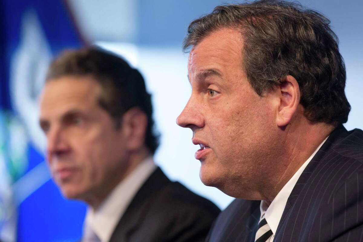 New York Governor Andrew Cuomo, left, listens as New Jersey Governor Chris Christie talks at a news conference on Oct. 24, 2014 in New York.