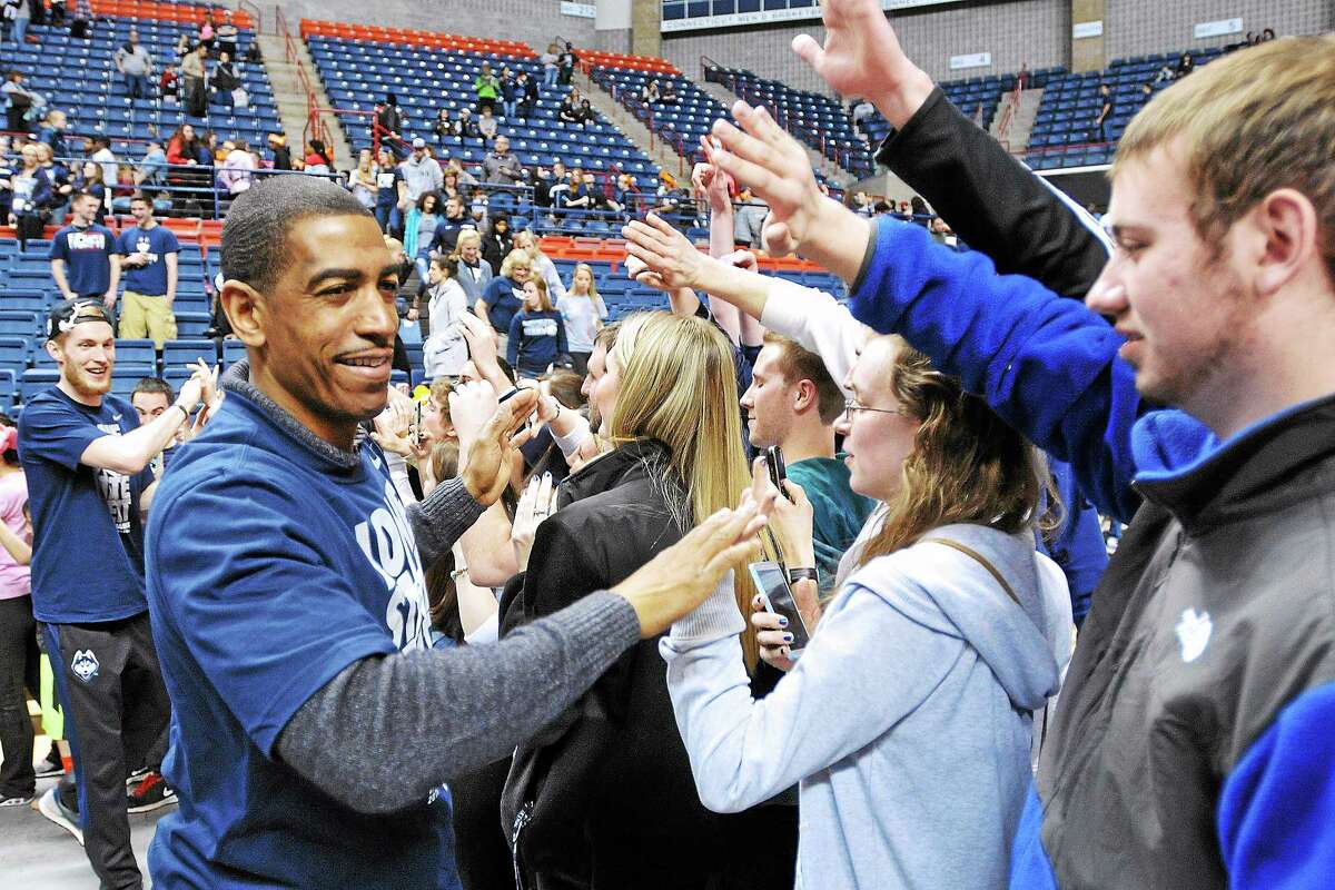 UConn coach Kevin Ollie, here receiving congratulations in Storrs following the Huskies’ national title, and his staff hit the recruiting trail recently looking for the next group of Huskies.