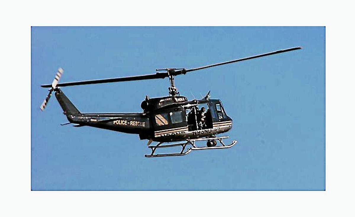 Eagle-1 takes part in manhunt for a fugitive in Milford, Conn. on October 7, 2011. A former U.S. Army UH-1H Huey helicopter, Eagle-1 is used as a search-and-rescue aircraft by police departments throughout Connecticut. (Credit: Connecticut Post)