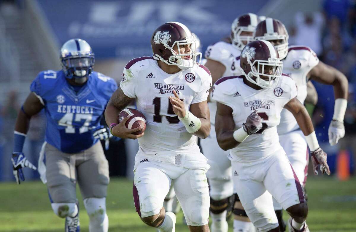 Mississippi State quarterback Dak Prescott, center, runs for a first down during the first half against Kentucky on Saturday.
