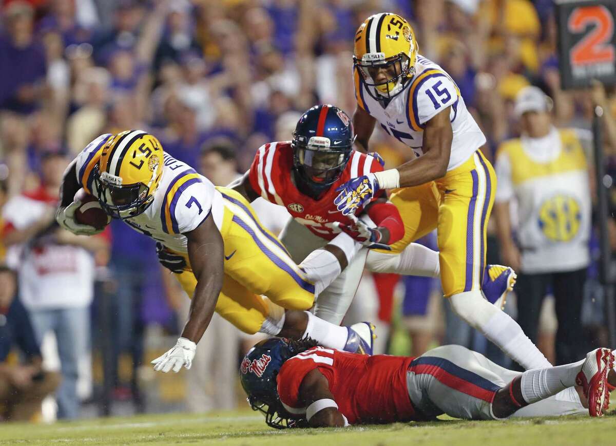 LSU running back Leonard Fournette (7) is tackled by Mississippi defensive backs Trae Elston, on ground, and Senquez Golson on Saturday.