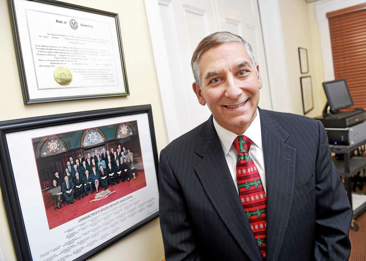 Newly elected State Senate Minority Leader Len Fasano is photograph in his office in New Haven on 12/23/2014. He is standing next to a photo of the State Senate from 2003 when he first served.
