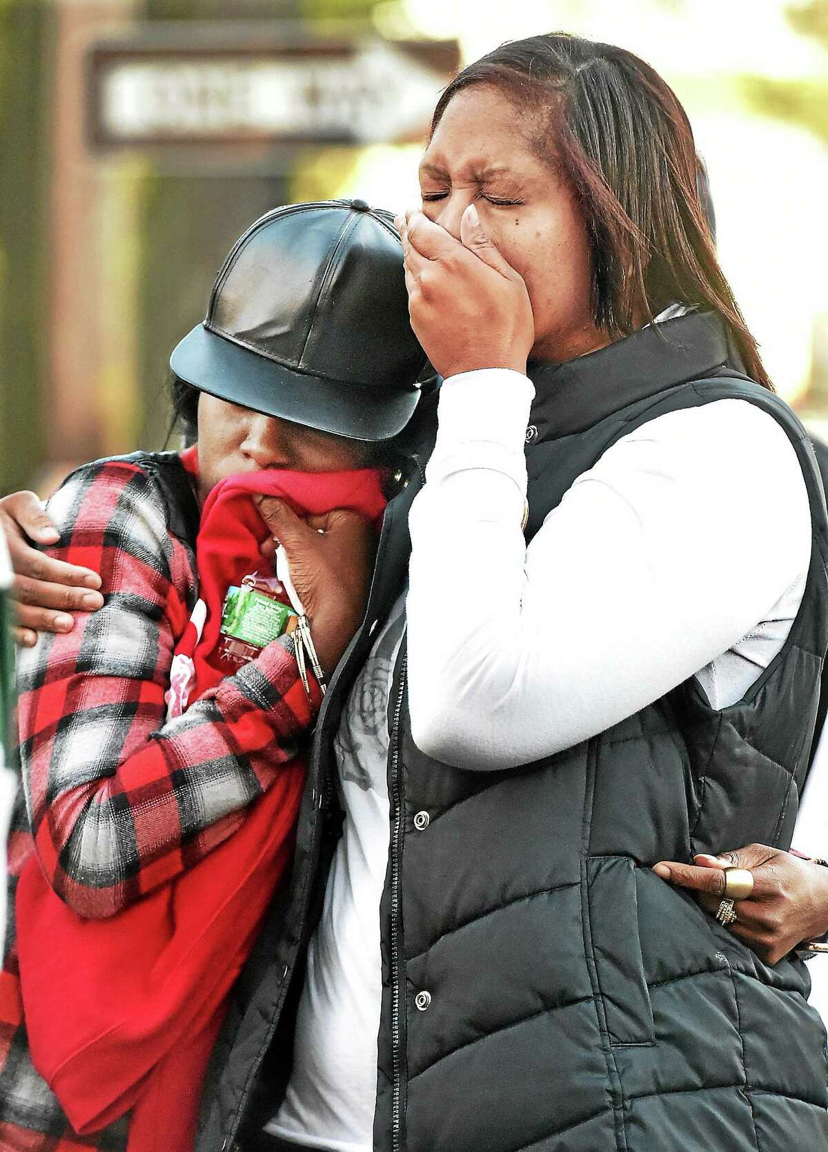 Yvette Sterling, left, a victim of the shooting at the Key Club Cabaret, and Karen London, a cousin of Erika Robinson, console each other at a vigil Sunday in memory of their best friend.