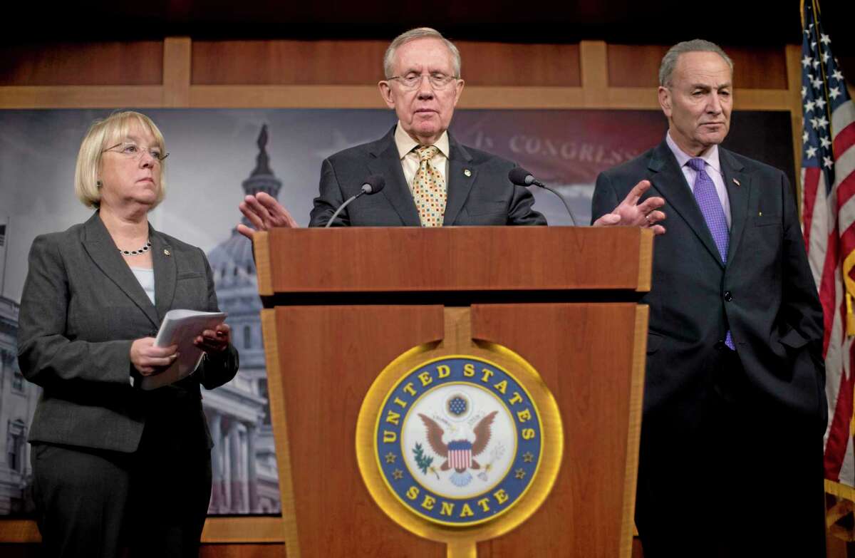 Senate Majority Leader Harry Reid of Nevada, center, accompanied by Sen. Patty Murray, D-Wash., left, and Sen. Charles Schumer, D-N.Y., gestures during a news conference about extending unemployment insurance benefits Thursday on Capitol Hill in Washington, D.C.