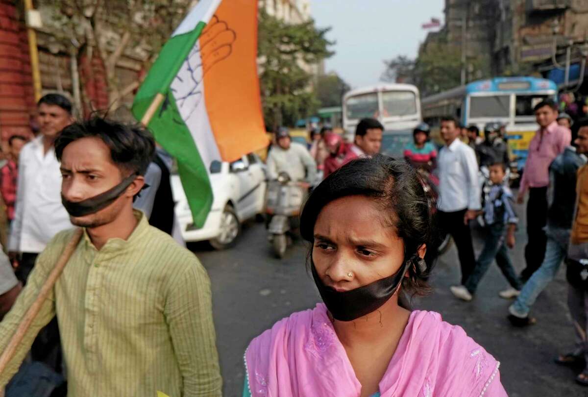 FILE - In this Friday, Jan. 3, 2014 file photo, activists of Indian National Congress with black bands around their mouths block traffic during a protest against a gang rape and murder of a 16-year-old girl at Madhyamgram, about 25 kilometers (16 miles) north of Kolkata in West Bengal, India. Her death on New Year's Eve came more than a year after a deadly gang rape in New Delhi raised awareness and outrage over chronic sexual violence in India and government failures to protect women. The New Delhi rape was considered a major reason for why voters ousted the capital's government last month, and the furious response to the West Bengal case suggests that with general elections just months away, politicians remain anxious to impress voters who are demanding that women's safety become a police priority. (AP Photo/Bikas Das, File)