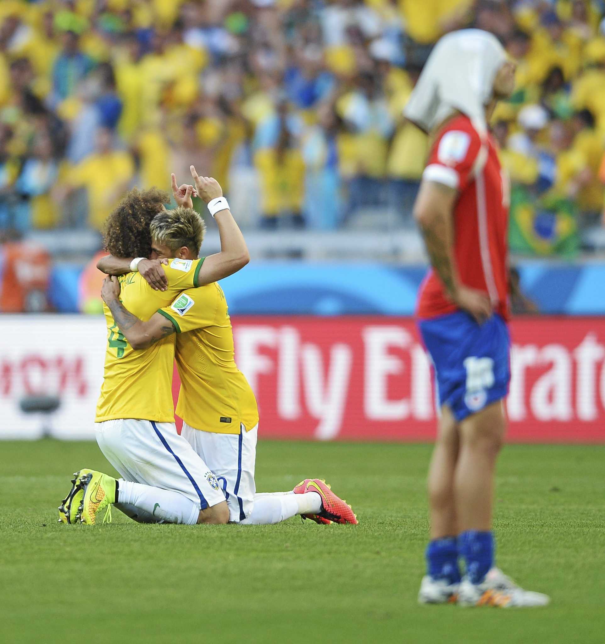 David Luiz of Brazil holds up Neymar's shirt prior to the 2014