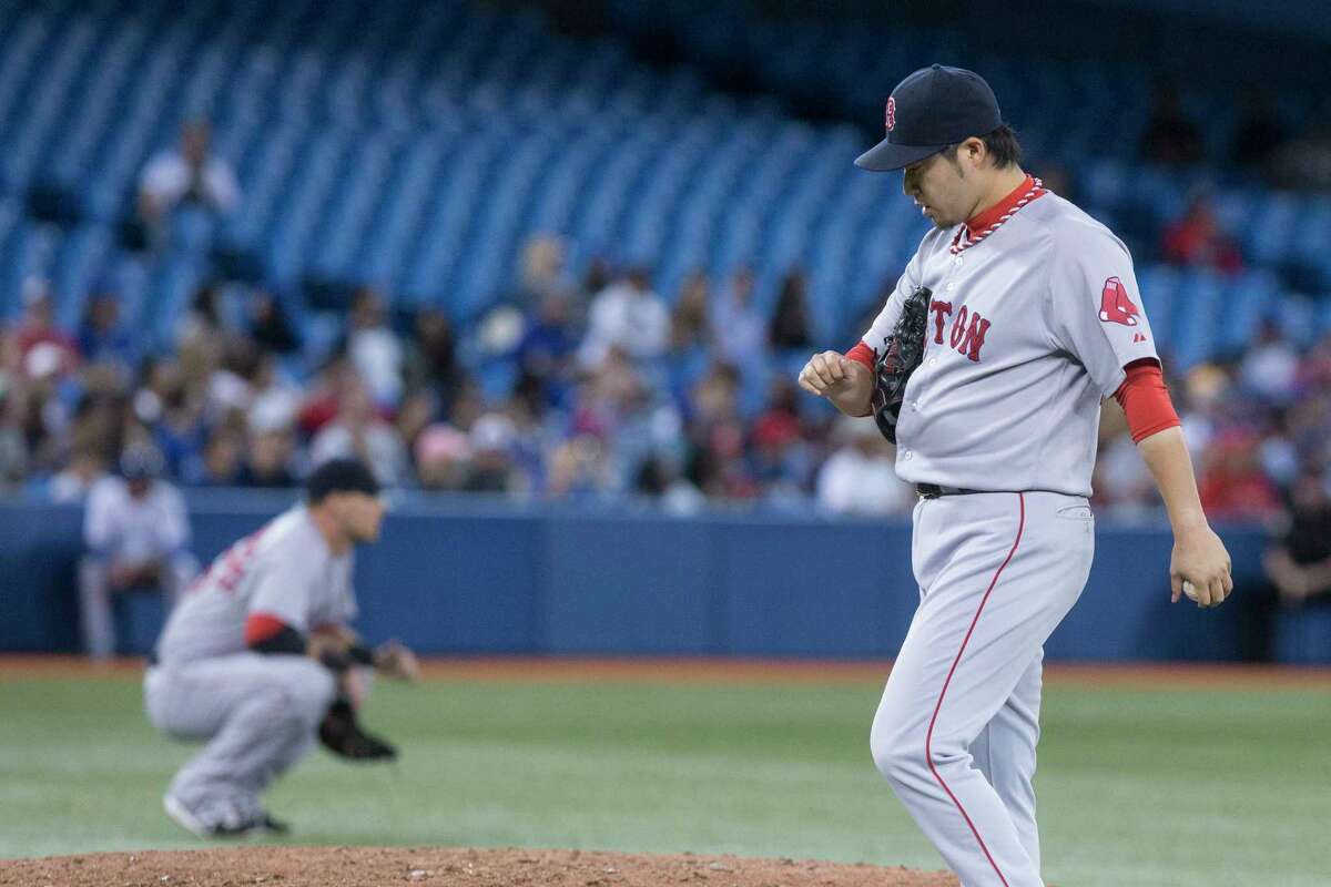Red Sox pitcher Junichi Tazawa reacts after Toronto Blue Jays’ Kevin Pillar hits a double during a four-run seventh inning in the Blue Jays’ 5-2 win.