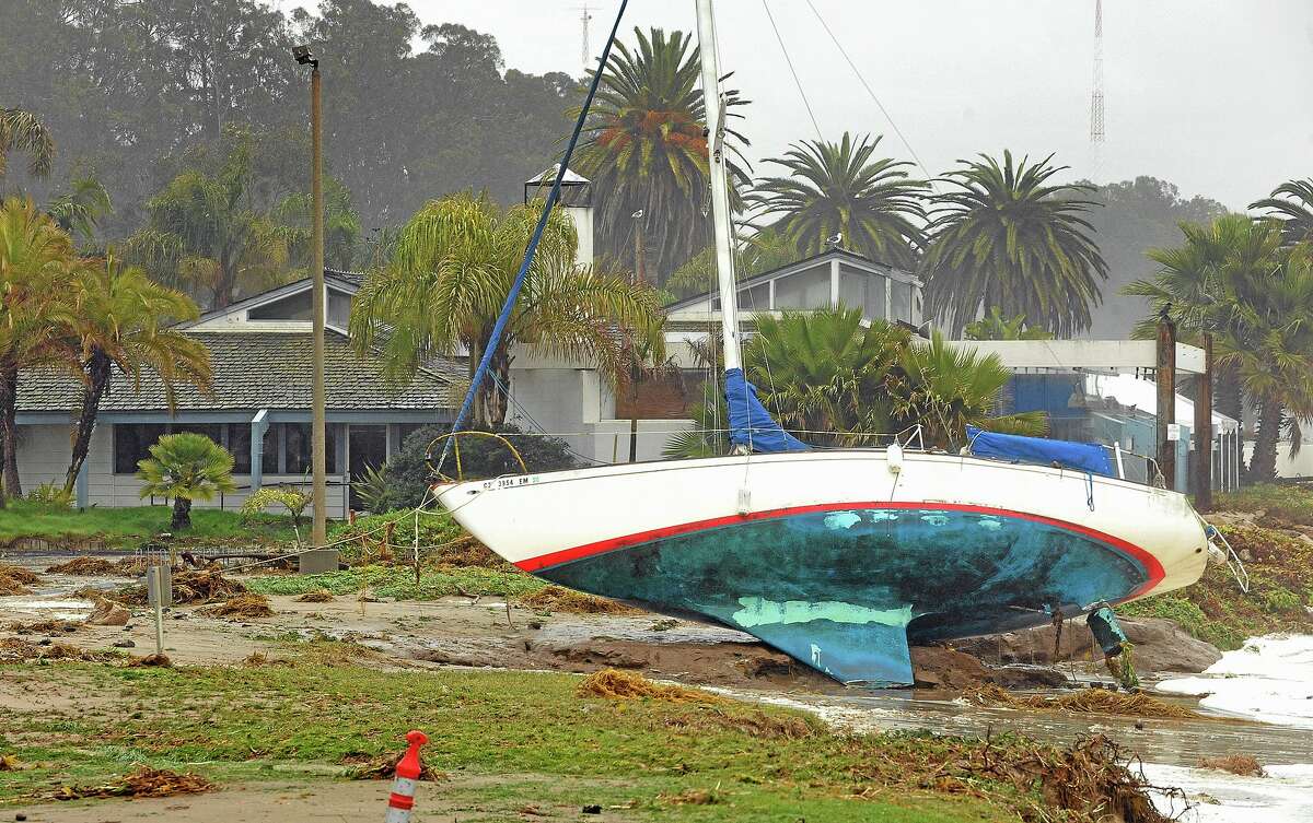 A sailboat washed ashore near a restaurant at Goleta, Calif., Saturday, March 1, 2014. The storm marked a sharp departure from many months of drought that has grown to crisis proportions for the stateís vast farming industry. However, such storms would have to become common to make serious inroads against the drought, weather forecasters have said. (AP Photo/The News-Press, Mike Eliason)