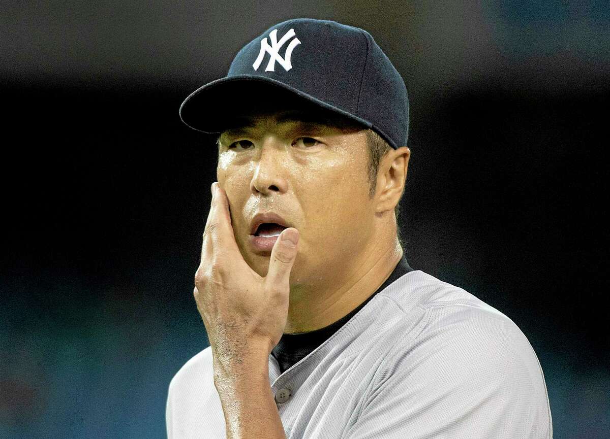 Yankees staring pitcher Hiroki Kuroda walks back to the dugout during the seventh inning against the Toronto Blue Jays on Wednesday.