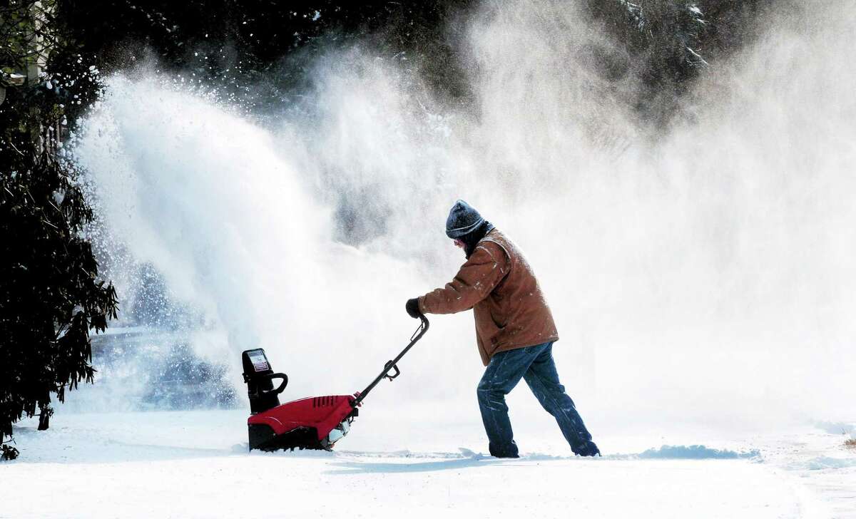 (Arnold Gold ó New Haven Register) Tom Neznek uses a snow blower to clear snow from the walkway at his house in Milford on 1/3/2014.