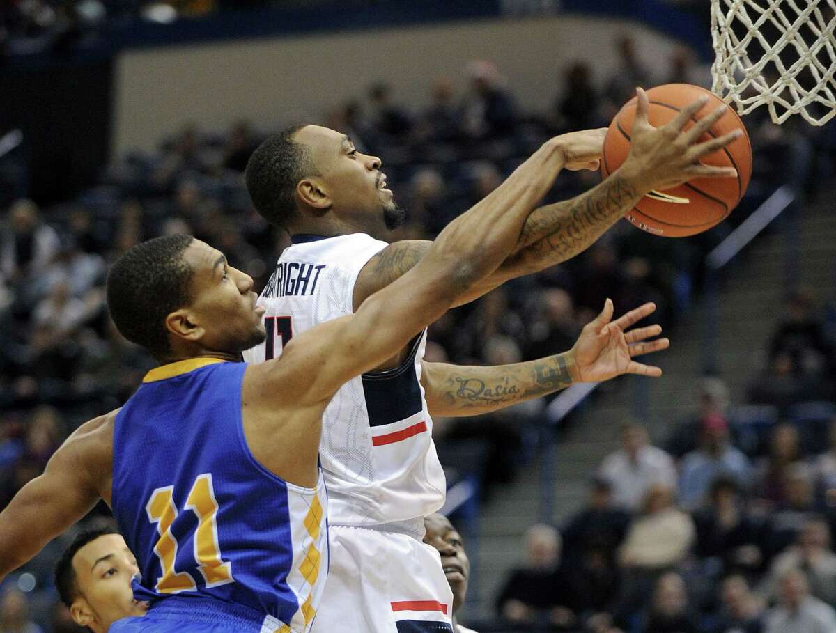 Connecticut’s Ryan Boatright (11) drives past Coppin State’s Taariq Cephas (11) during the first half .