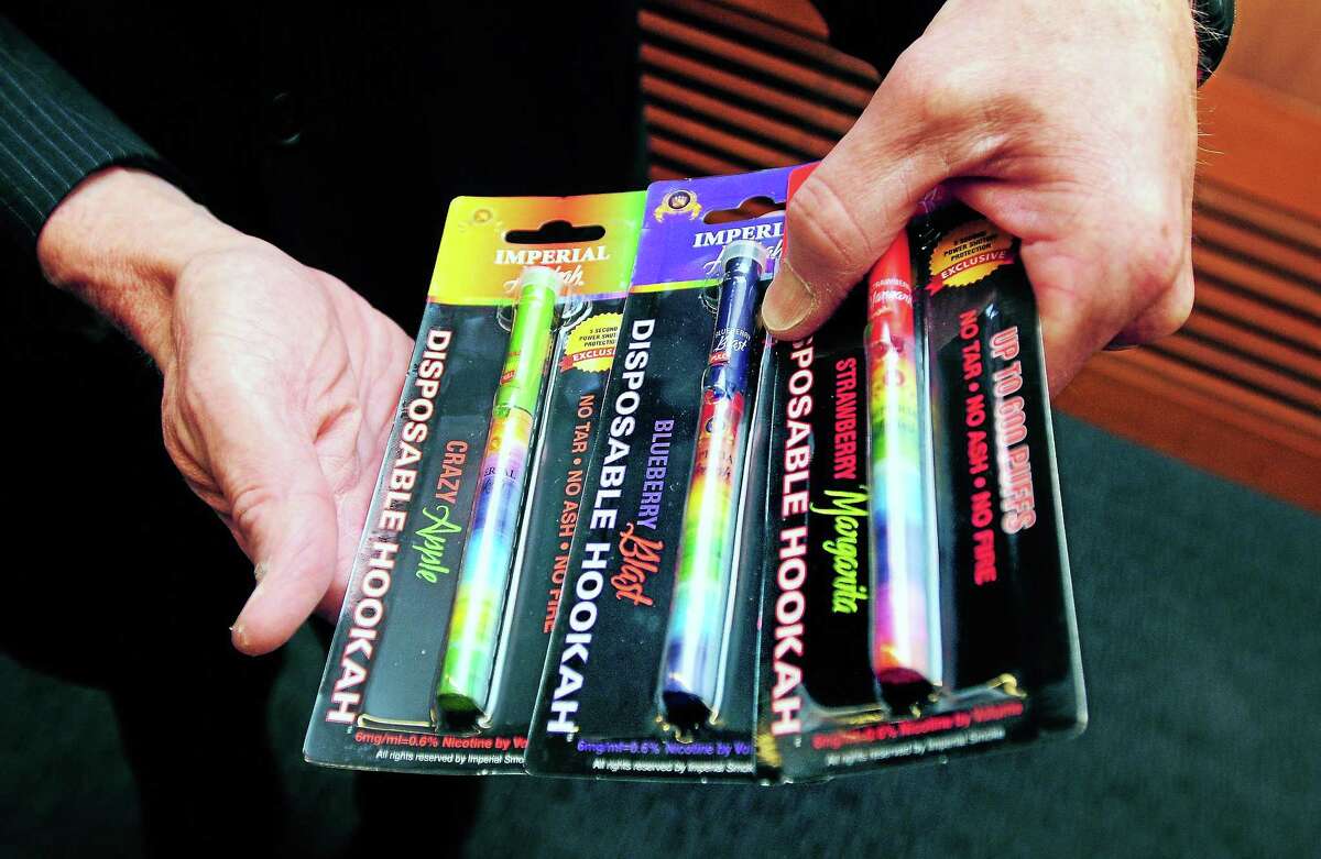 U.S. Sen. Richard Blumenthal, D-Conn., holds packages of e-cigarettes before a press conference calling for more action restricting the sale and use of e-cigarettes.