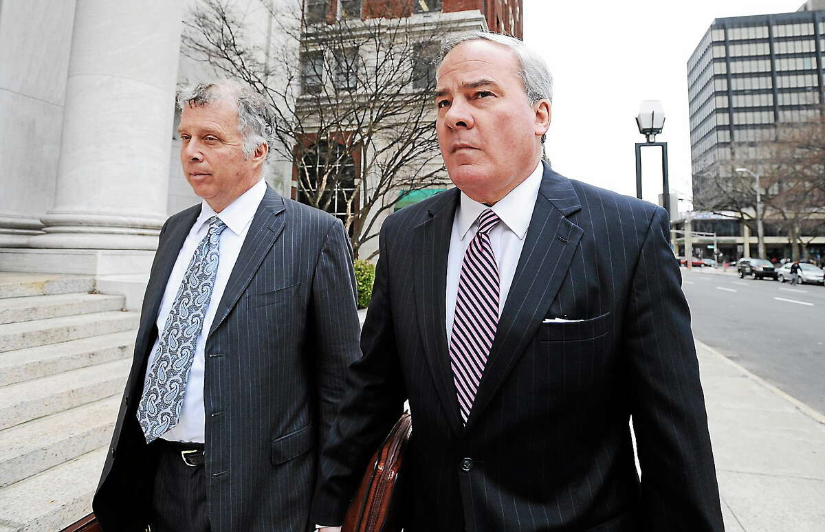 Former Connecticut Gov. John G. Rowland arrives with attorney Reid Weingarten at federal court on April 11, 2014, in New Haven, Conn. A grand jury returned a seven-count indictment alleging Rowland schemed to conceal involvement with congressional campaigns.
