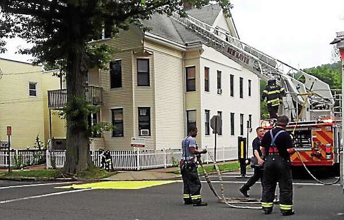 Fire crews extinguished a house fire Tuesday morning at 31 Canner St. in New Haven. Lt. Ben Vargas said the fire started with a light fixture on the second floor and extended to the third floor of the home.