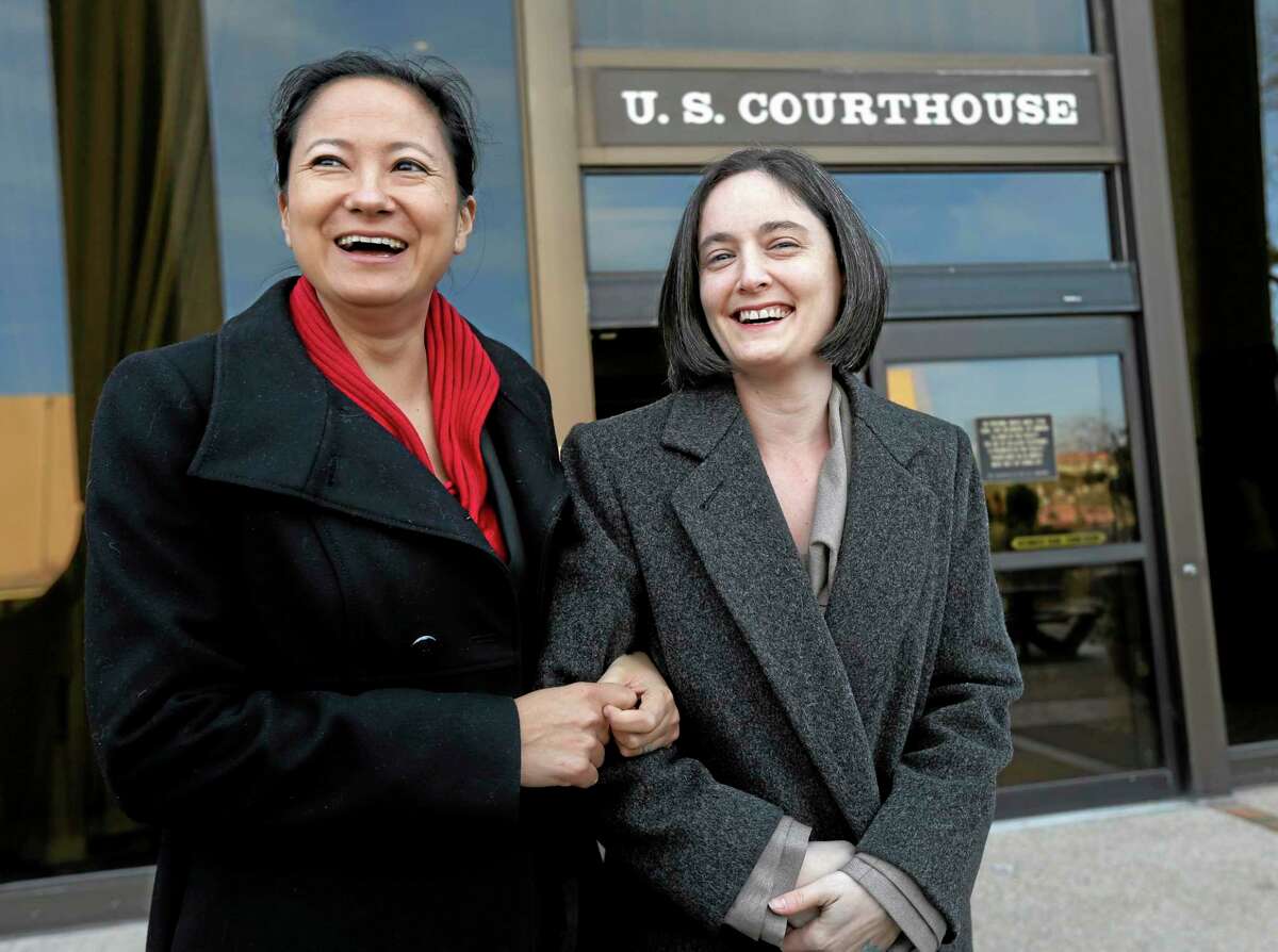 File - In this Feb. 12, 2014 file photo, Cleopatra De Leon, left, and partner, Nicole Dimetman, right, arrive at the U.S. Federal Courthouse, in San Antonio, where a federal judge is expected to hear arguments in a lawsuit challenging Texas' ban on same-sex marriage. On Wednesday, Feb. 26, 2014, Judge Orlando Garcia has struck down the ban but is leaving it in place pending a ruling by an appeals court later this year. (AP Photo/Eric Gay, File)