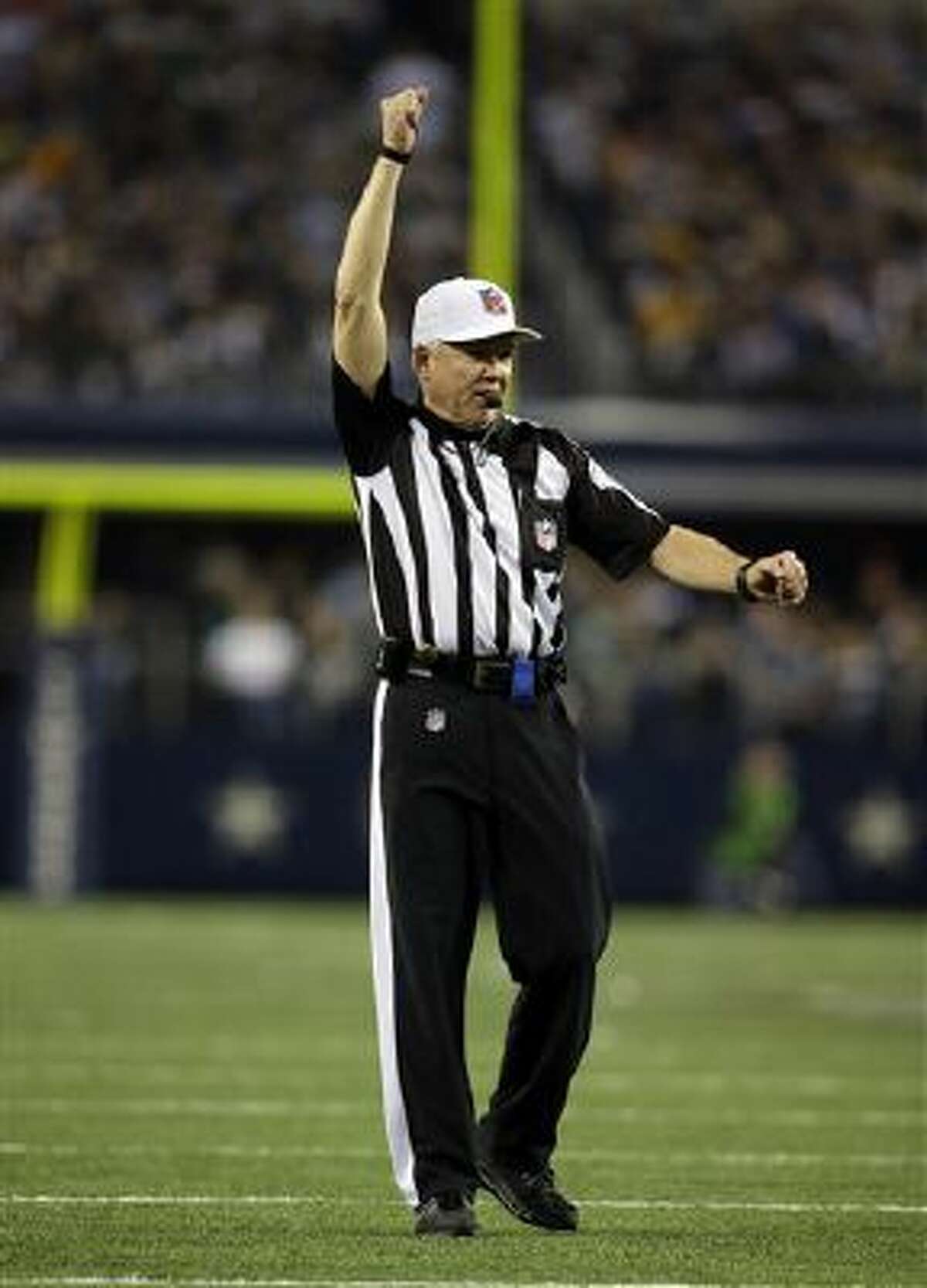 Line judge Walt Coleman IV (65) runs across the field during an NFL  football game between the Arizona Cardinals and Dallas Cowboys, Monday,  Oct. 19, 2020, in Arlington, Texas. Coleman also wears