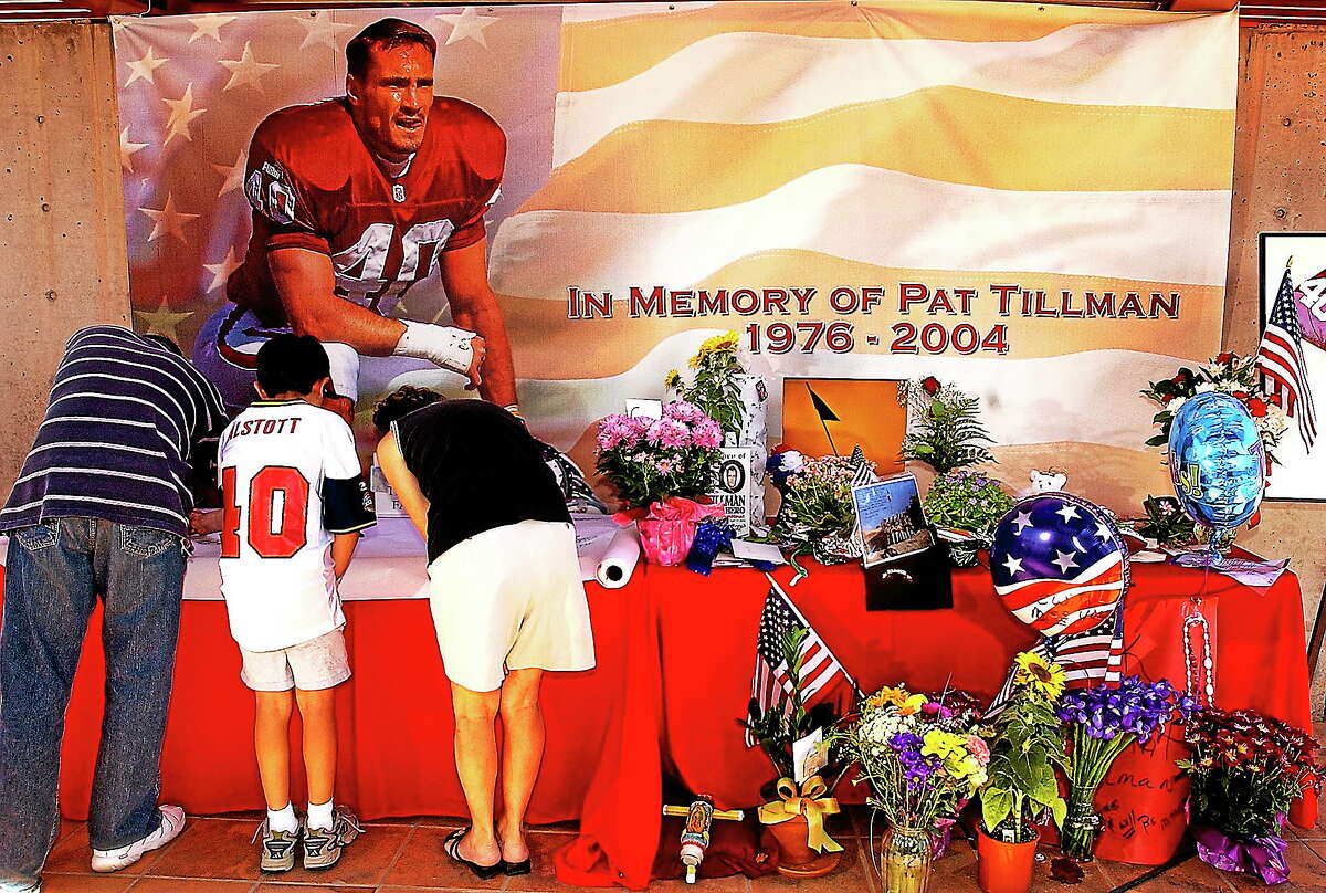 Fans sign a memorial for former Arizona Cardinal and U.S. Army Ranger Pat Tillman on April 23, 2004 at the Cardinals training facility in Tempe, Ariz. The 10-year anniversary of Tillman’s death is this week. ESPN will air an episode of Outside the Lines on Sunday morning in which a fellow Ranger says he may be the one who fired the fatal shots.