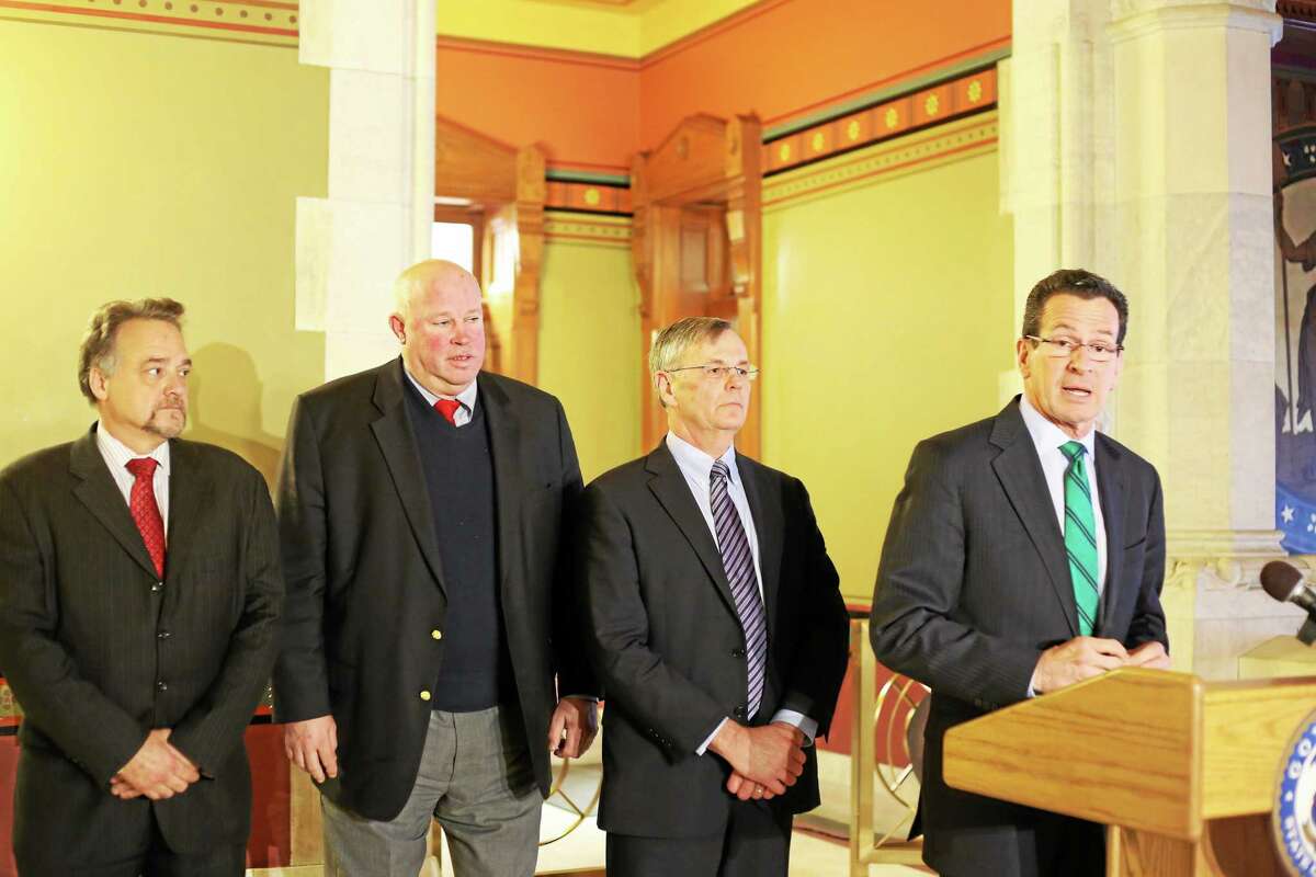 Christine Stuart-CTNewsJunkie.com Metro-North President Joseph Giuletti, left, listens as Gov. Dannel P. Malloy speaks at a press conference earlier this month. Also pictured are MTA Chairman and CEO Thomas Prendergast, second from left, and DOT Commissioner James Redeker.