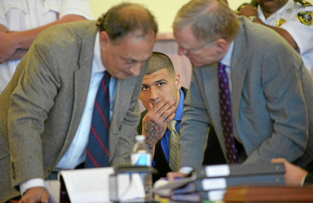 Former New England Patriots NFL football player Aaron Hernandez watches his defense attorneys James Sultan and Charles Rankin during a hearing at the Bristol County Superior Court House, Monday, June 16, 2014, in Fall River, Mass. Hernandez's attorneys challenged the evidence in one of his murder cases, arguing at a pretrial hearing that prosecutors have not established probable cause in the fatal shooting of Odin Lloyd. (AP Photo/Faith Ninivaggi, Pool)