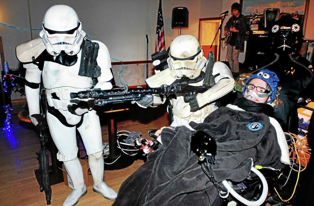 (Arnold Gold-New Haven Register) Jonathan Bowkowski (right) is escorted into his birthday party by Imperial Stormtroopers at the Irish American Community Center in East Haven on 4/19/2014.