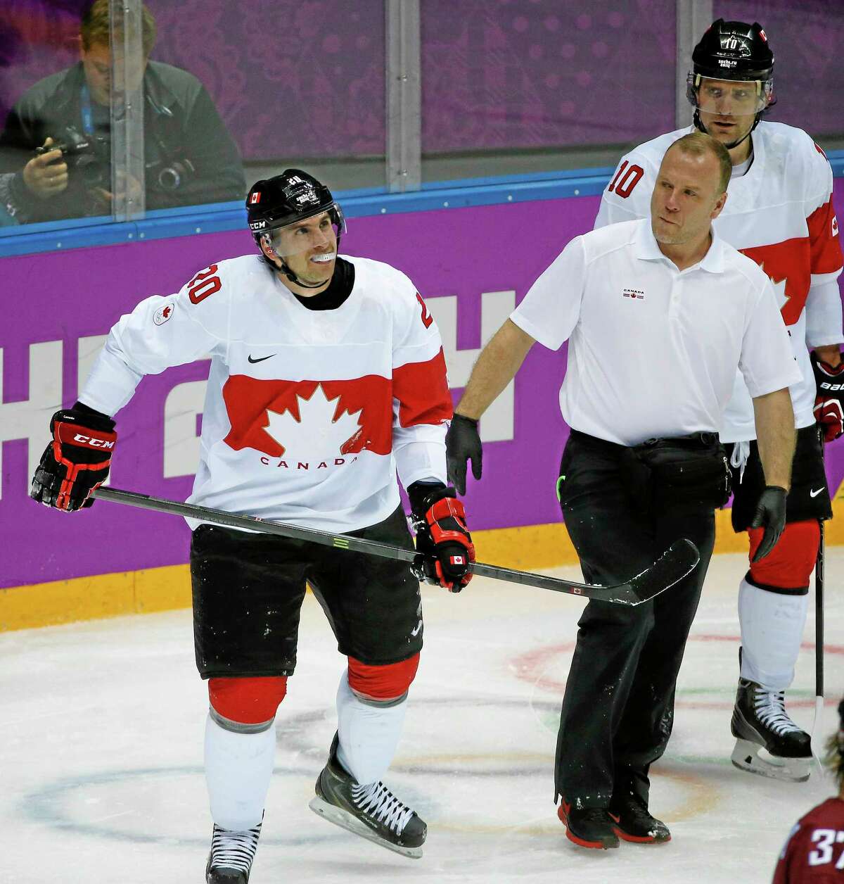Canada forward John Tavares skates off the ice with a trainer after sustaining a knee injury during the second period of a men’s quarterfinal game against Latvia at Winter Olympics last Wednesday in Sochi, Russia. The Islanders captain will not need surgery.