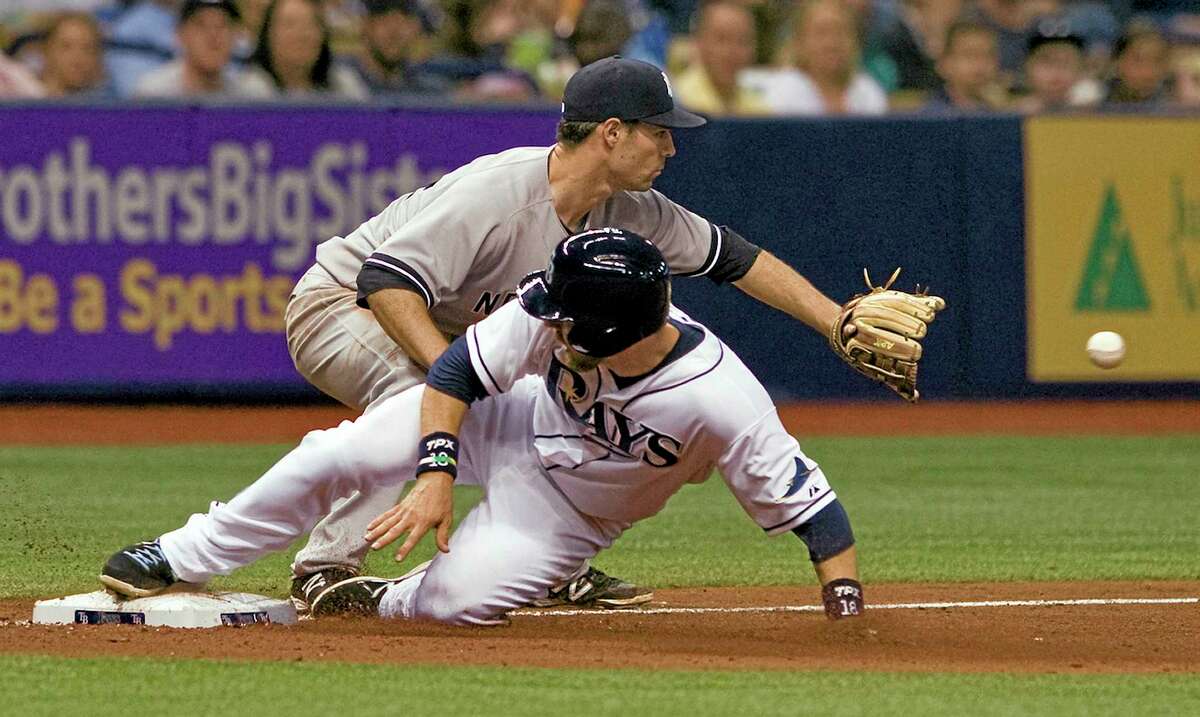 The Rays’ Ben Zobrist, bottom, beats the throw to New York Yankees third baseman Scott Sizemore on a single by pinch-hitter Desmond Jennings in Friday’s game.