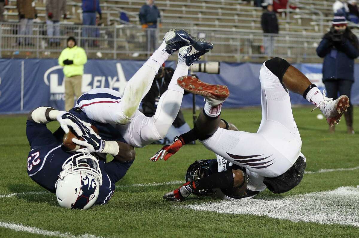 UConn safety Junior Lee hauls in an apparent interception on a pass to Cincinnati receiver Nate Cole during a Nov. 22 game in East Hartford. After review, the interception was nullified. Cincinnati won 41-0.