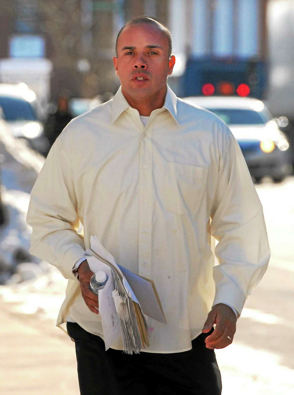Angelo Reyes of New Haven runs to a hearing at Federal Court in Hartford in 2011.
