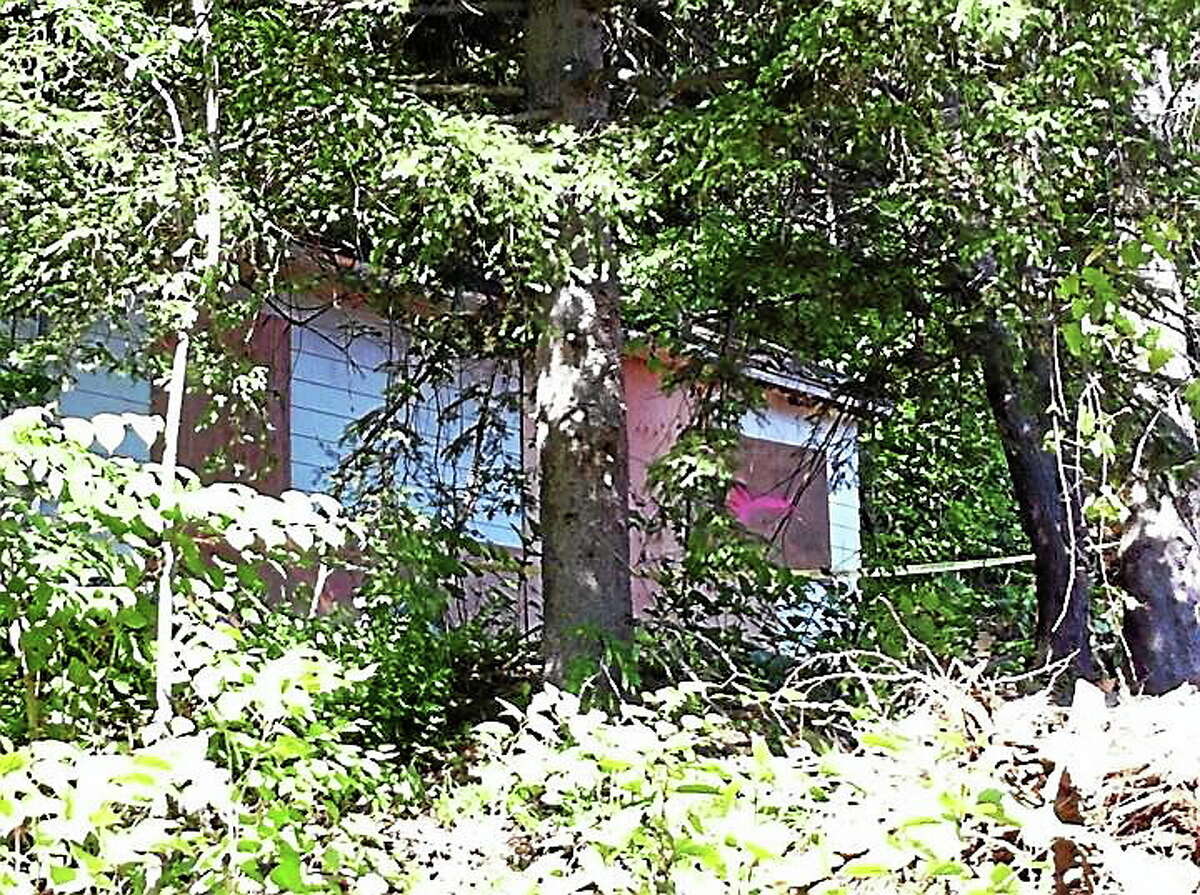 The boarded-up home of Beverly Mitchell, 66, who was found dead by authorities on Saturday, June 14, 2014.
