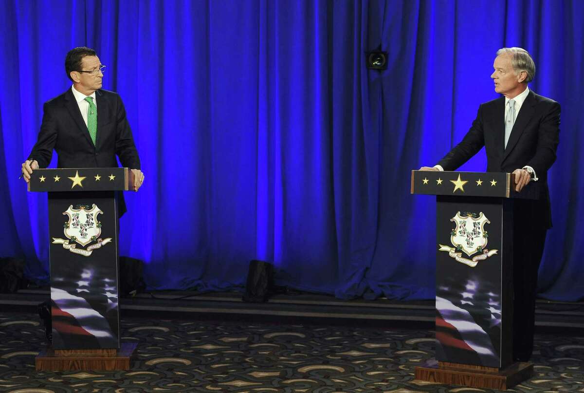 Gov. Dannel P. Malloy, left, and Republican candidate for governor Tom Foley look at one another during an exchange about gun laws during a debate Thursday in Hartford.