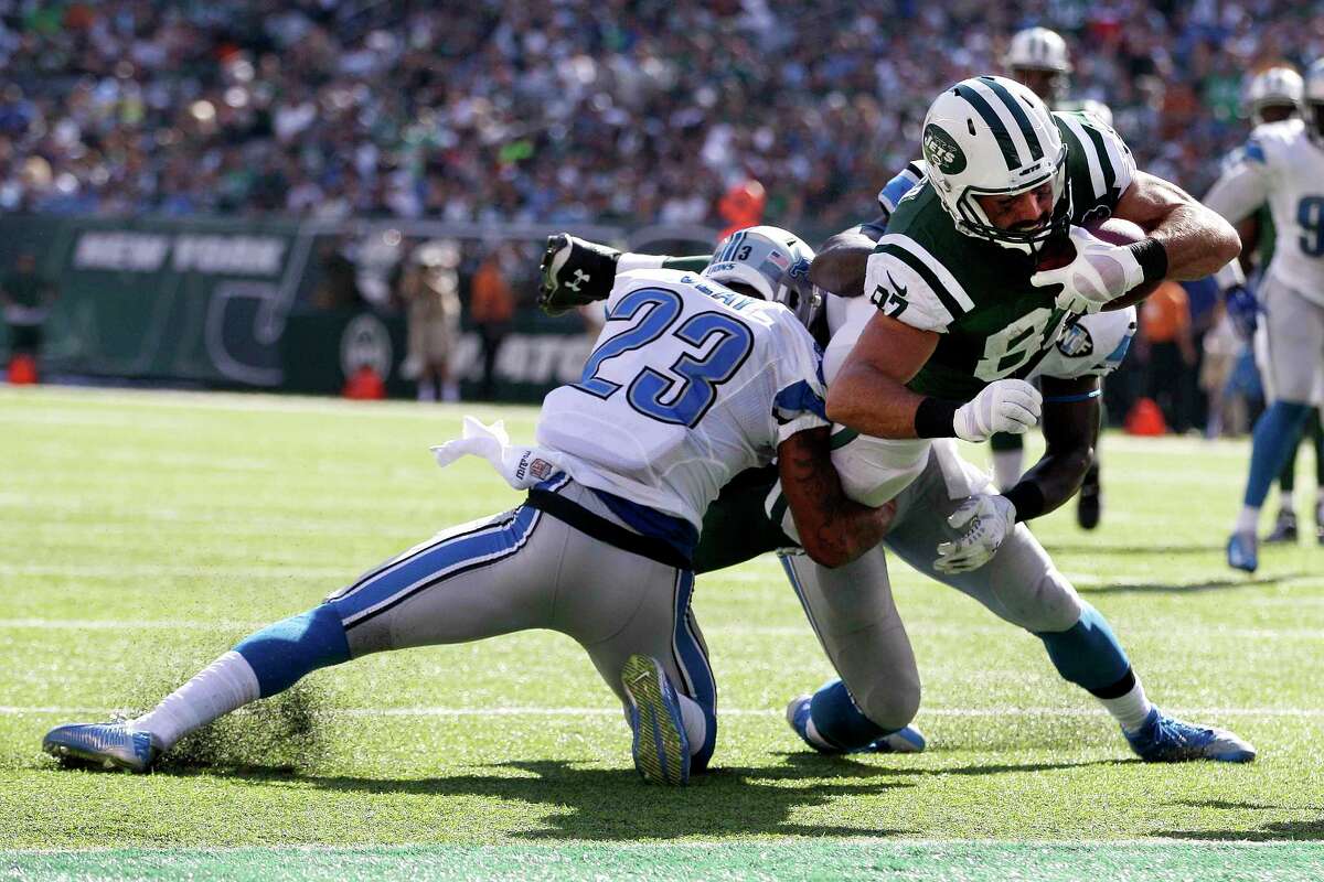 New York Jets receiver Eric Decker, center, dives in between Detroit Lions cornerback Darius Slay, left, and outside linebacker Tahir Whitehead for a touchdown on Sept. 28 in East Rutherford, N.J.