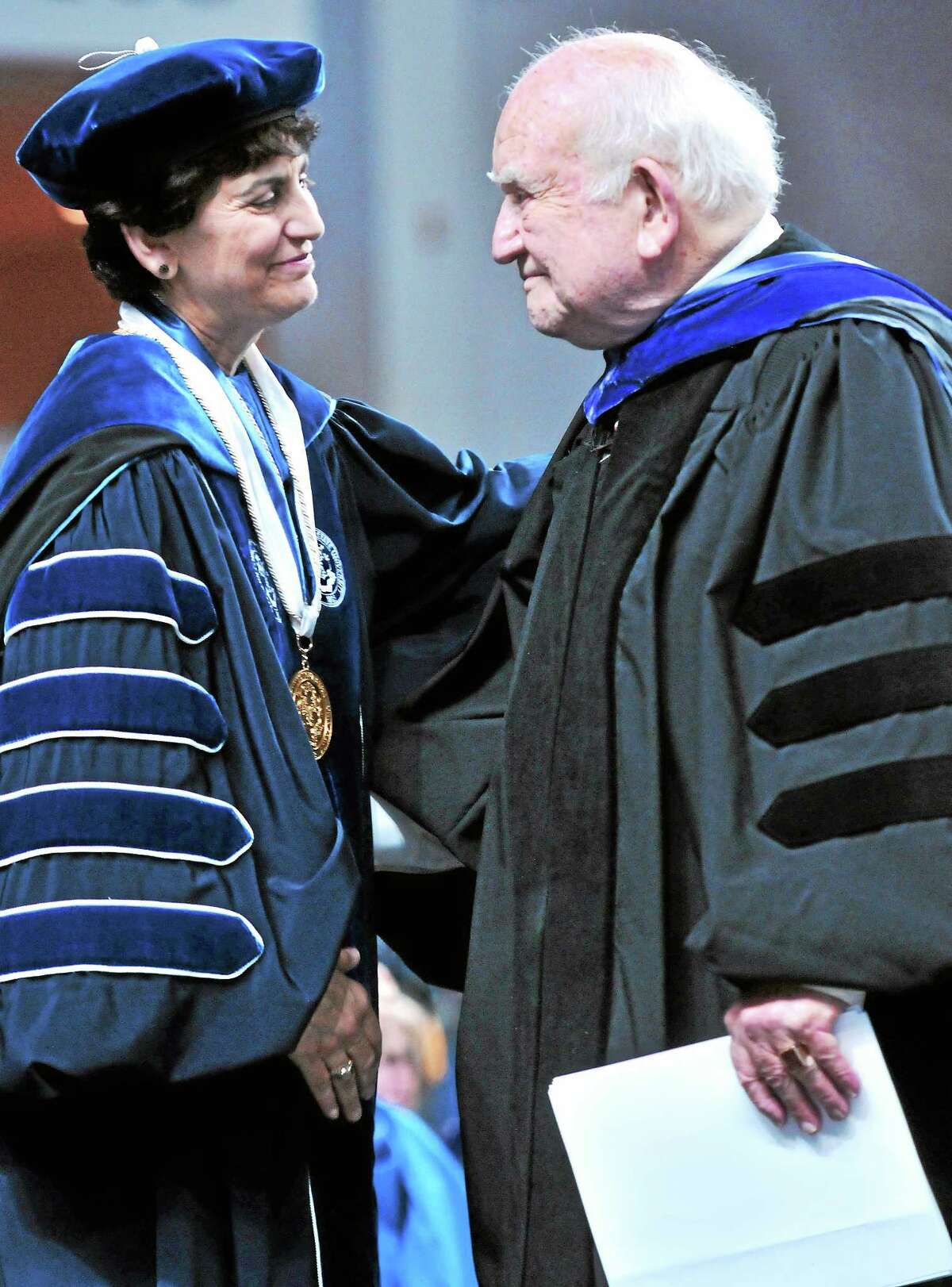 Southern Connecticut State University President Mary Papazian, left, and Edward Asner embrace after Asner gave the Undergraduate Commencement address for Southern at Webster Bank Arena in Bridgeport in May.