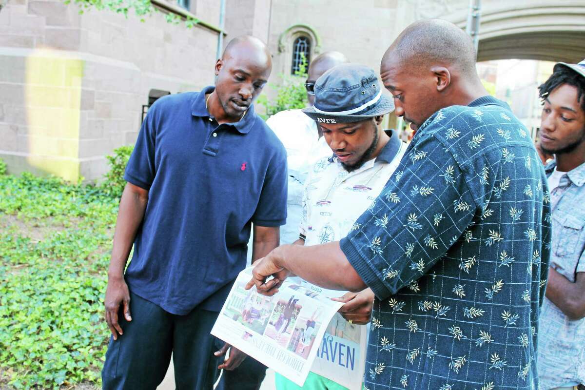 City residents talk about racism over an image shown in Yale Daily News.