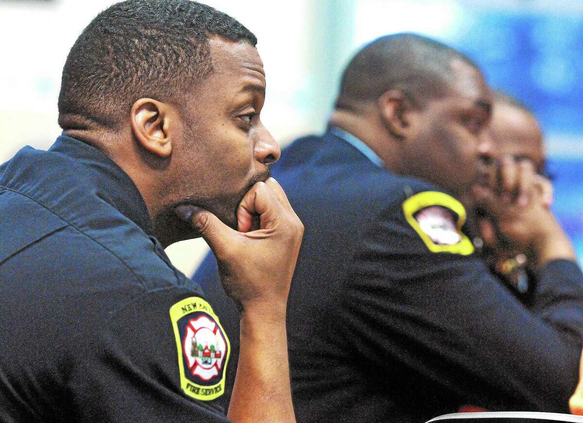 Firefighters listen as New Haven Fire Chief Allyn Wright speaks during the Greater New Haven NAACP meeting at St. Luke’s Church Thursday.