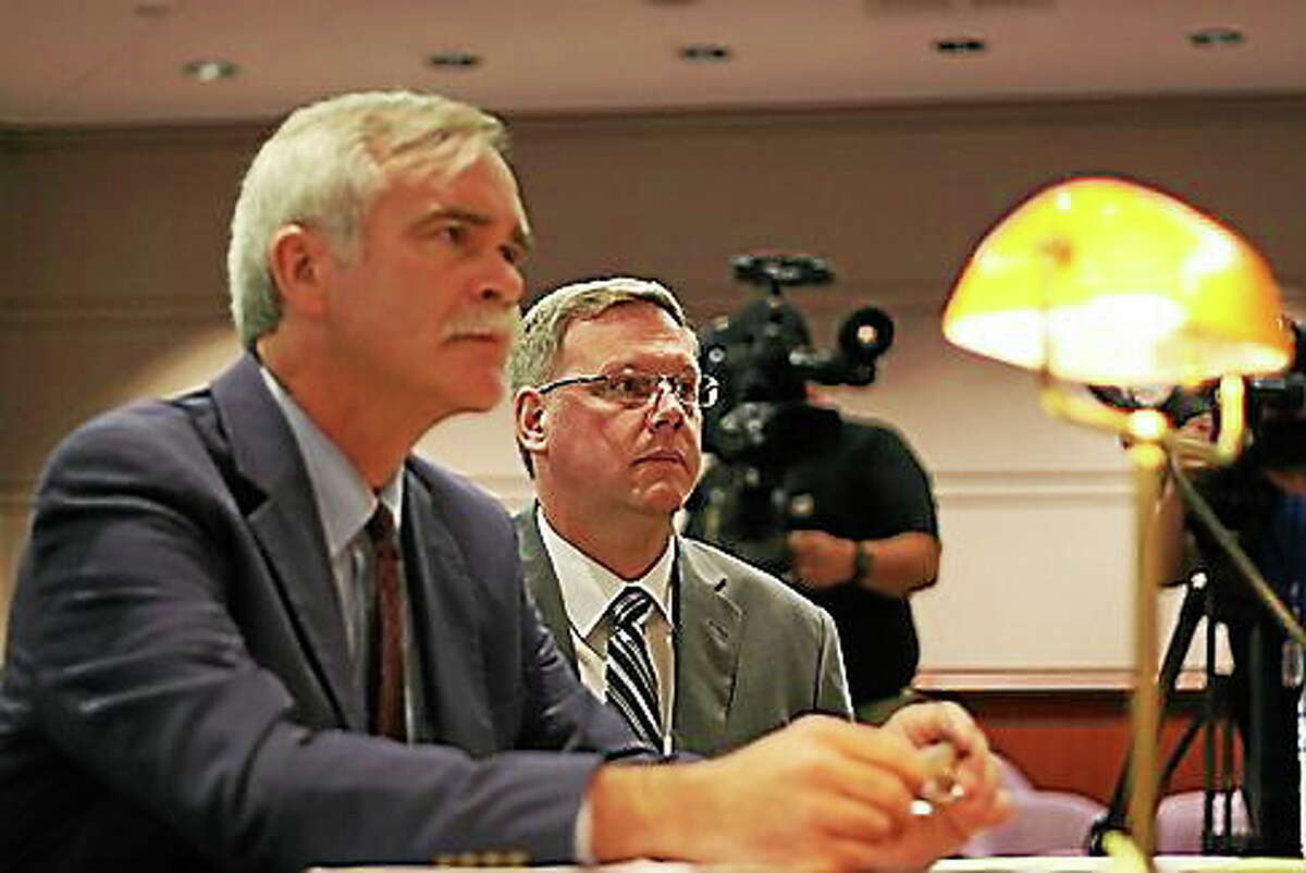 Kenneth Ireland, right, and his attorney William Bloss at a hearing before Claims Commisisoner J. Paul Vance Jr. in July.