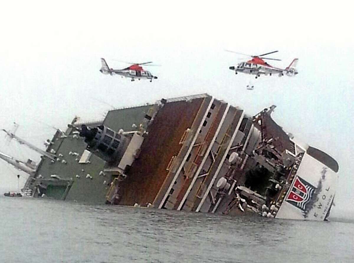 Rescue helicopters fly over a sinking South Korean passenger ferry that was carrying more than 450 passengers, mostly high school students, Wednesday, April 16, 2014, off South Korea's southern coast. Hundreds of people are missing despite a frantic, hours-long rescue by dozens of ships and helicopters. At least four people were confirmed dead and 55 injured. (AP Photo/Yonhap) KOREA OUT