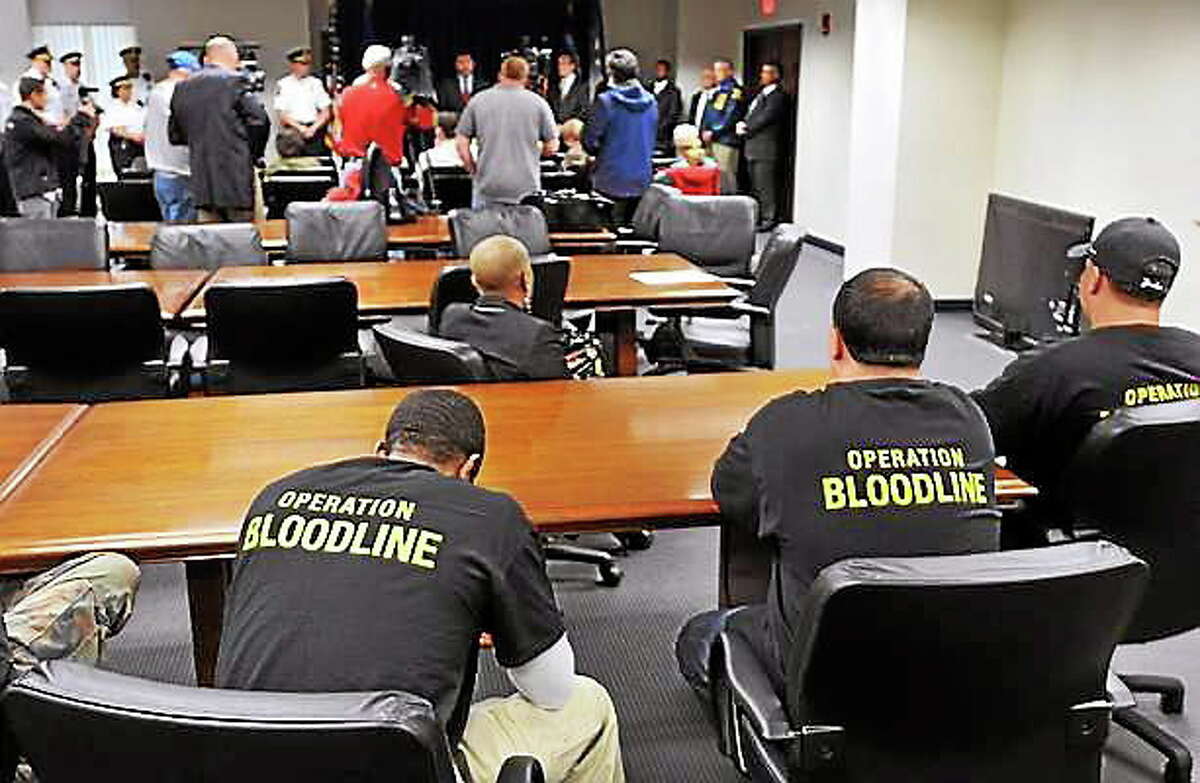 DEA agents wear special shirts with “Operation Bloodline” at a press conference in May 2012 announcing that 105 individuals have been charged with New Haven-area narcotic trafficking and firearm offenses.