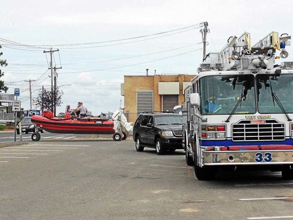 West Shore firefighters rescued three fisherman who became stranded Tuesday on the rocks near Prospect Beach in West Haven. The three men were not hurt but were being evaluated for hypothermia.
