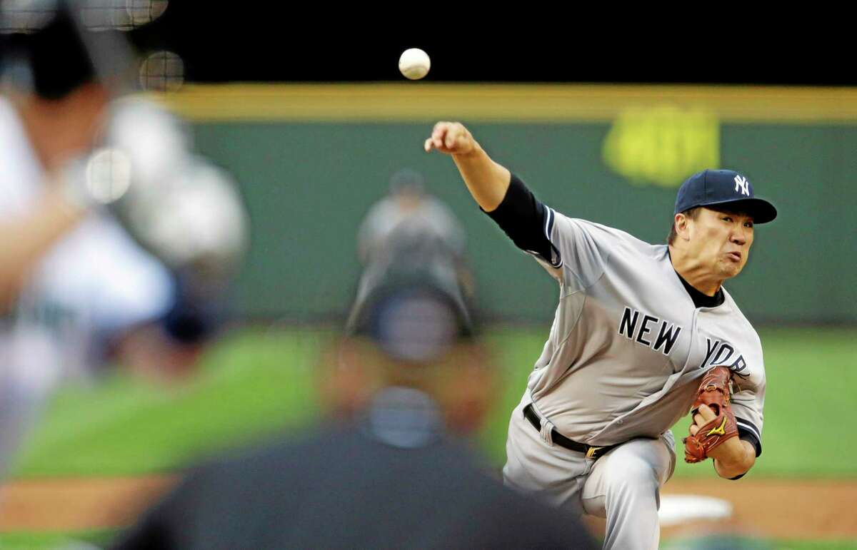 New York Yankees starting pitcher Masahiro Tanaka throws against the Seattle Mariners in the fourth inning Wednesday.
