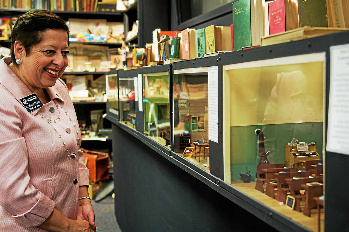 Rebecca Palacios, an early childhood educator from Corpus Christi, Texas, and 2014 inductee into the National Teachers Hall of Fame, walks along a display case of classroom dioramas at the hall in Emporia, Kan. The hall will dedicate a memorial to educators who have been killed on the job.