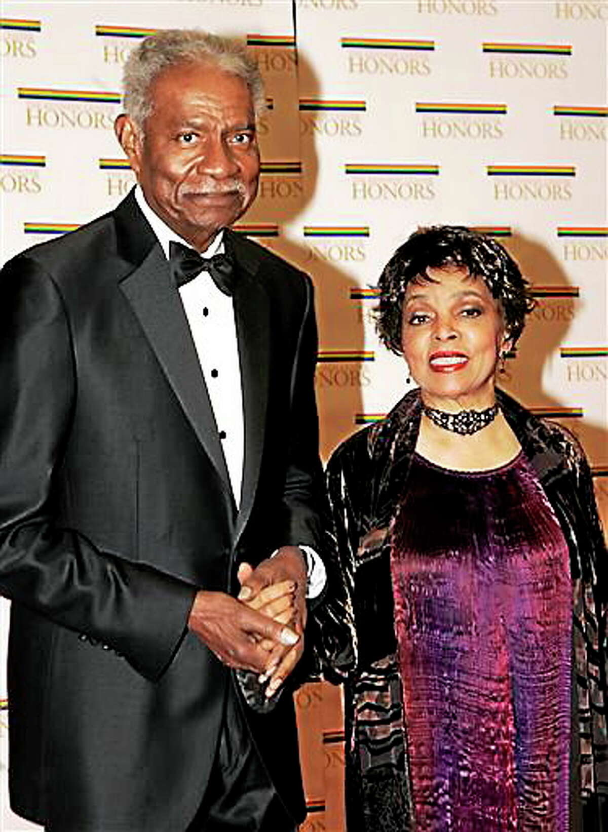 In this Dec. 4, 2004, file photo, husband-and-wife actors, writers and producers Ossie Davis and Ruby Dee arrive at the State Department for a dinner celebrating them and the other Kennedy Center honorees, in Washington. Dee, an acclaimed actor and civil rights activist whose versatile career spanned stage, radio television and film, has died at age 91, according to her daughter. Nora Davis Day told The Associated Press on Thursday, June 11, 2014, that her mother died at home at New Rochelle, New York, on Wednesday night.